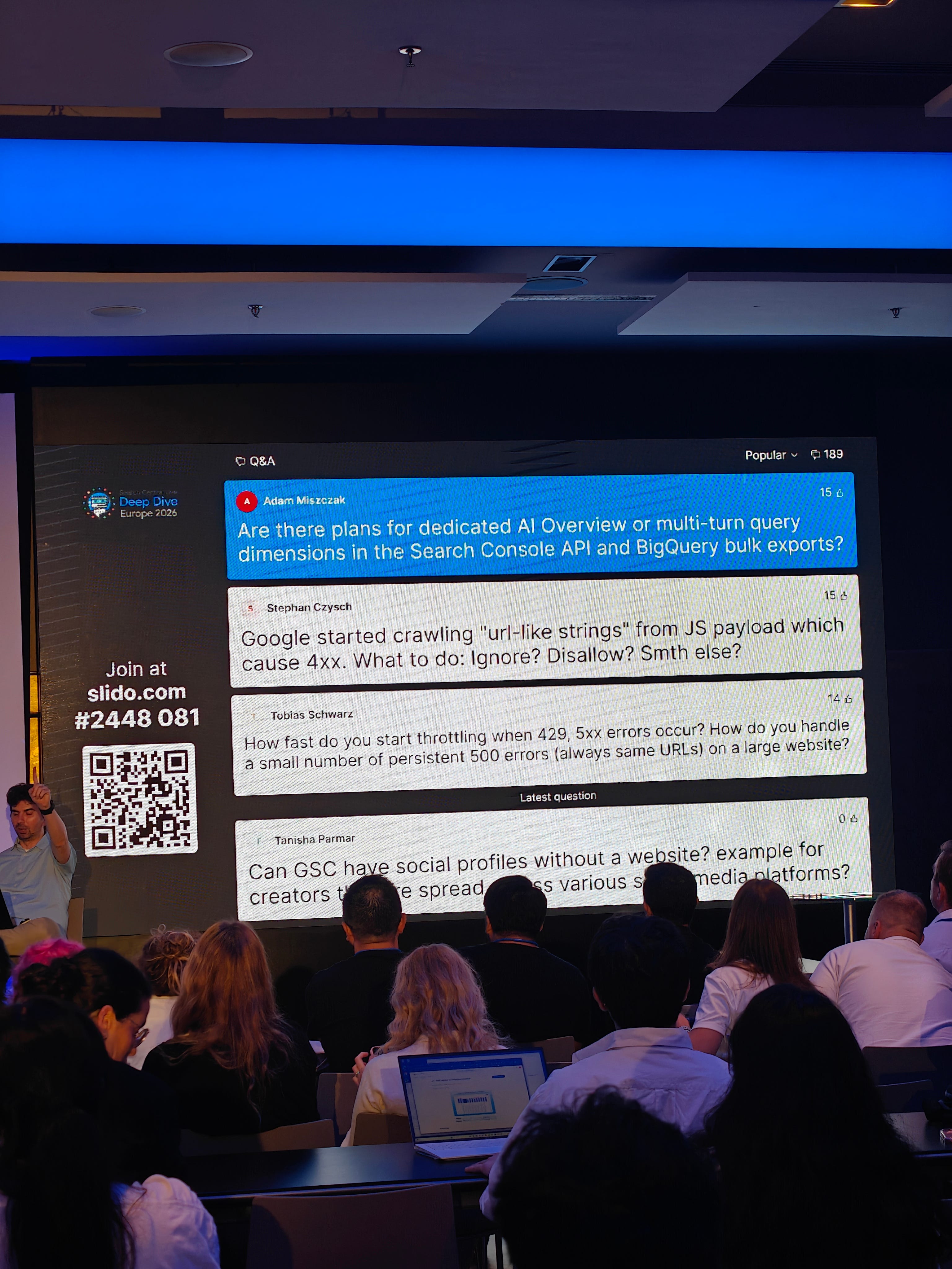 Slido screen at Google Search Central Live Deep Dive showing Adam Miszczak asking about AI Overview and multi-turn query dimensions in Search Console API and BigQuery exports.