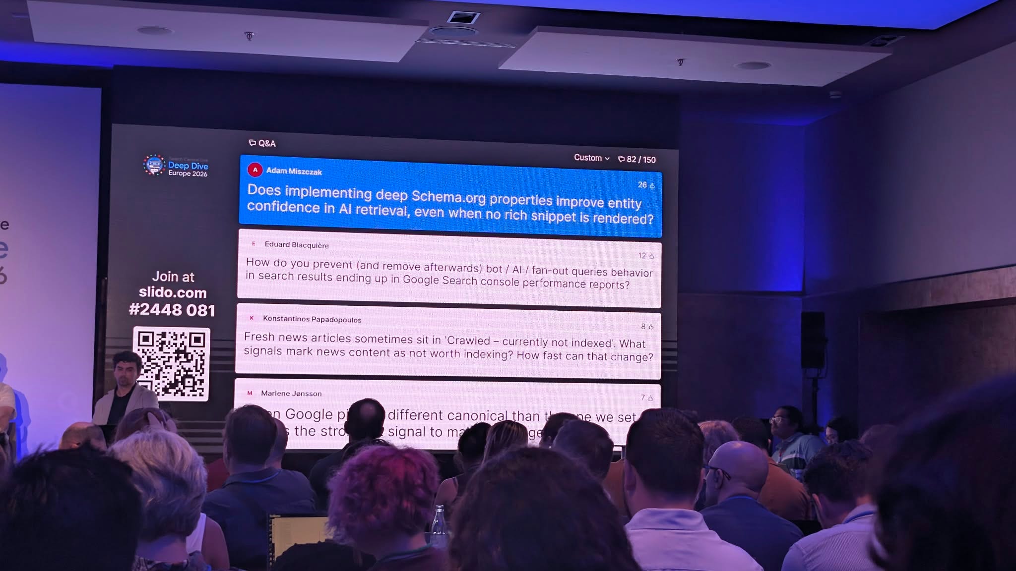 Slido screen at Google Search Central Live Deep Dive showing Adam Miszczak's question about Schema.org properties and entity confidence in AI retrieval.